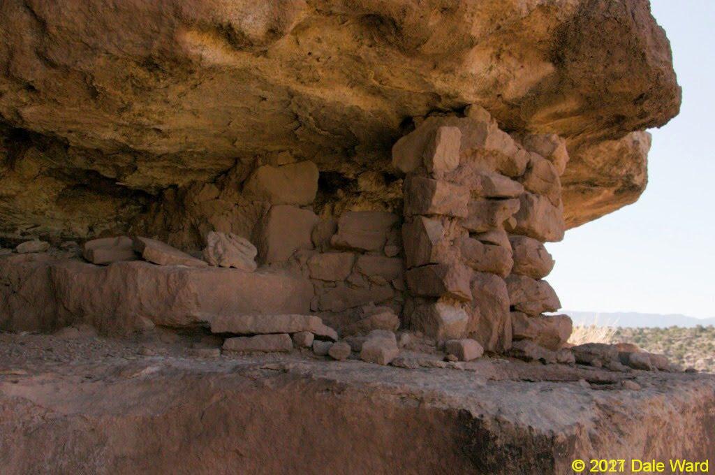 Looking at the ruin under the boulder ledge